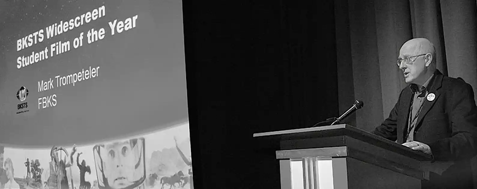 speaker standing at lecture hall lectern